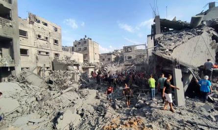 Palestinians inspect buildings destroyed by Israeli airstrikes in Jabaliya refugee camp on the outskirts of Gaza City in October.