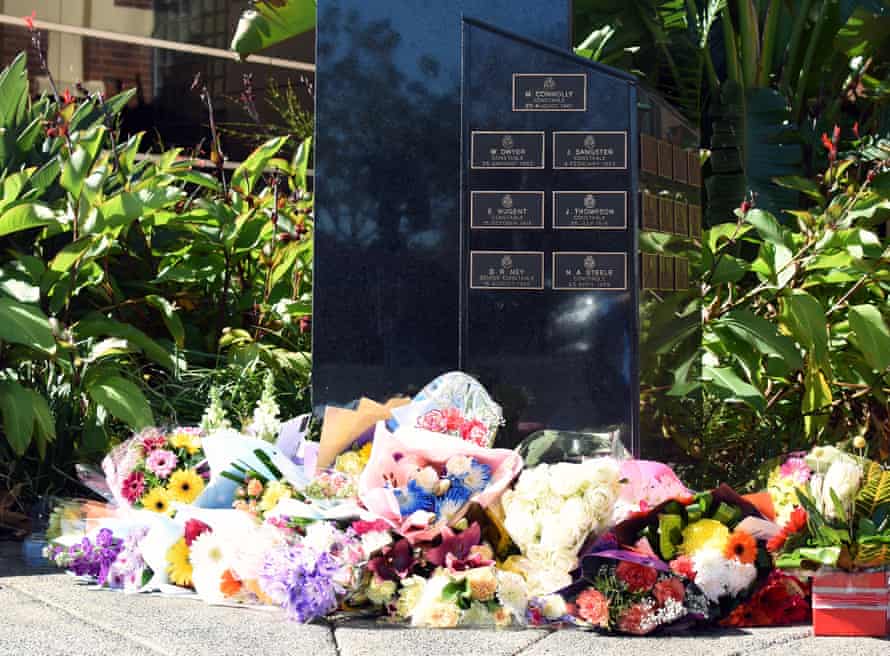 Flowers are laid in memory of killed police officer at the entrance to Toowomba police station in Queensland on Tuesday.