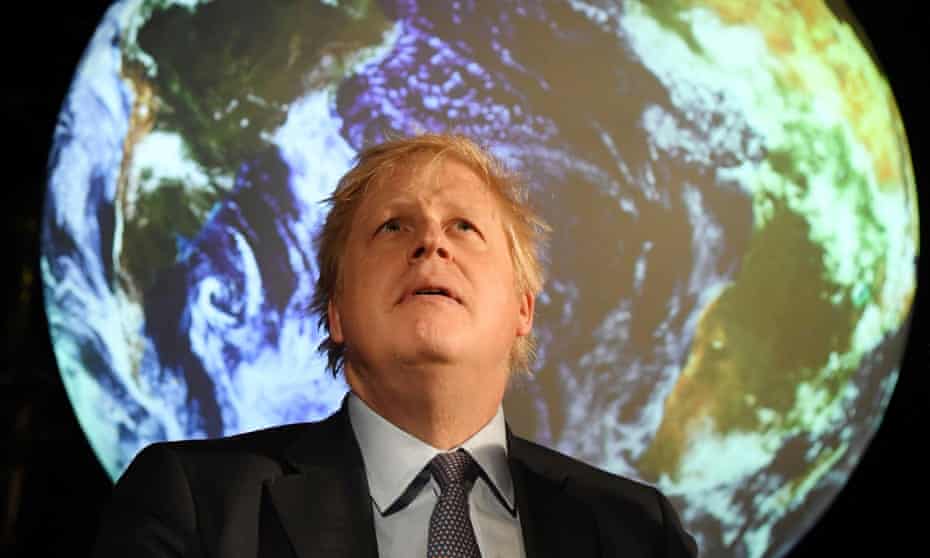 Boris Johnson in front of an image of Earth