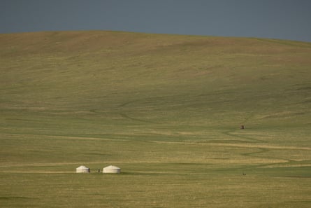 Two gers stand alone against the vast openness of the steppe