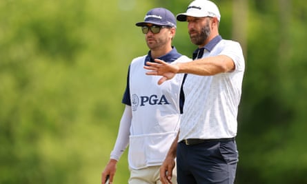 Dustin Johnson of the United States talks with his brother and caddie Austin
