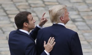 The French president, Emmanuel Macron, and his US counterpart, Donald Trump walk in the courtyard of Les Invalides in Paris as part of an official welcoming ceremony.