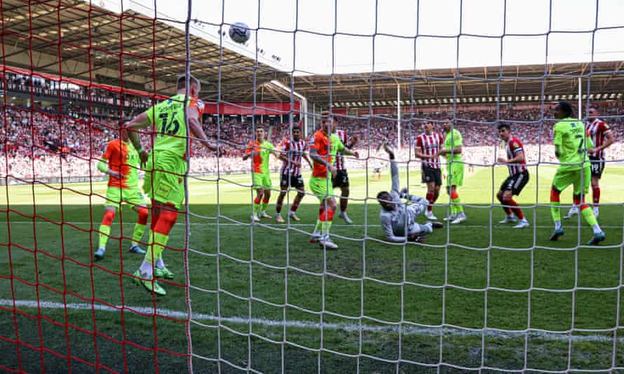Sam Surridge of Nottingham Forest heads off the line from John Egan of Sheffield United.