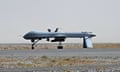 A US Predator unmanned drone armed with a missile stands on the tarmac of Kandahar military airport.