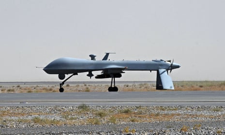 A US Predator unmanned drone armed with a missile stands on the tarmac of Kandahar military airport. 