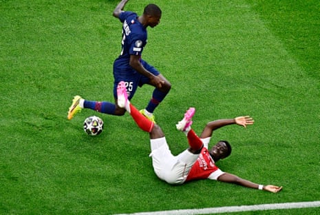 Arsenal's Bukayo Saka is felled by Paris St Germain's Nuno Mendes.