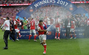 Alexis Sanchez leads the champagne celebrations.