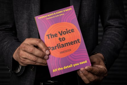 Thomas Mayo holds the book he has coauthored with journalist Kerry O’Brien titled The Voice to Parliament Handbook