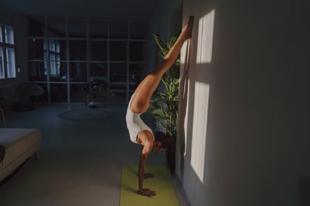 woman doing handstand at home