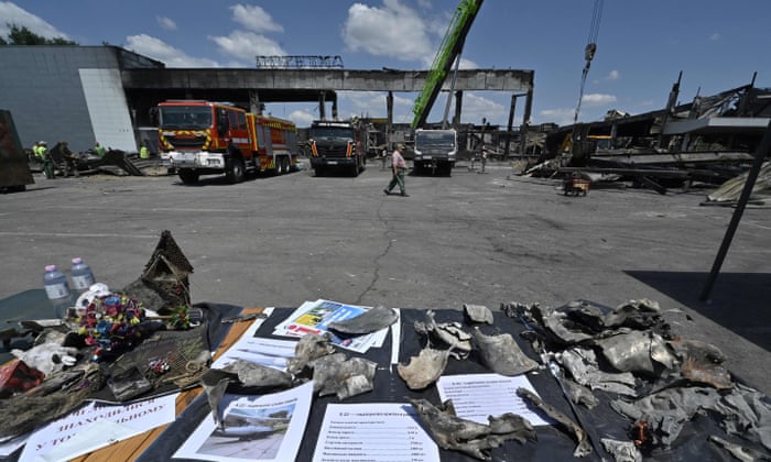 Fragments of a missile are laid out on a table, as workers and rescuers clear rubble from the Kremenchuk shopping centre