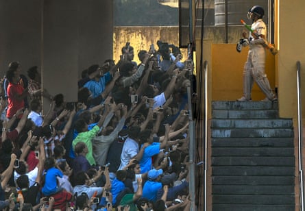 Sachin Tendulkar walks out to bat one last time during second test match between India and West Indies at the Wankhede Stadium in Mumbai on November 16, 2013. The build up to this last series of Tendulkar’s saw a huge outpouring of emotion from the press and fans, some of whom were lucky to get vantage points in the stadium for that last picture of the famous cricketer.
