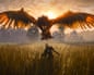 A screenshot showing a huge bird-like creature looming over a man in a corn field.