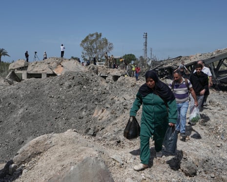 People cross on foot after an Israeli airstrike that destroyed a bridge near Tyre, Lebanon