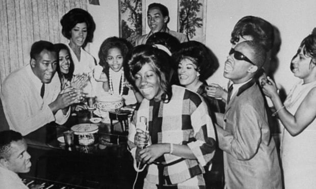Berry Gordy plays piano as a group including Smokey Robinson and Stevie Wonder join in singing together at Motown Studios