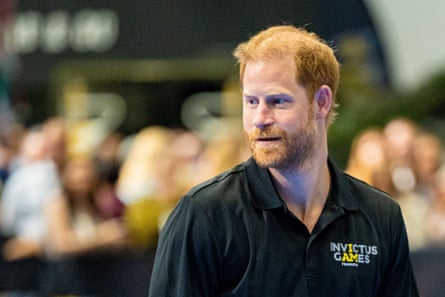 Prince Harry at the NEC: he wears a black polo shirt with an Invictus Games logo.