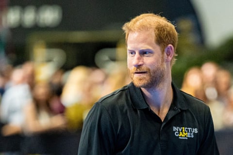 Prince Harry at the NEC: he wears a black polo shirt with an Invictus Games logo.