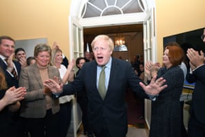 Boris Johnson surrounded by clapping people in 10 Downing Street