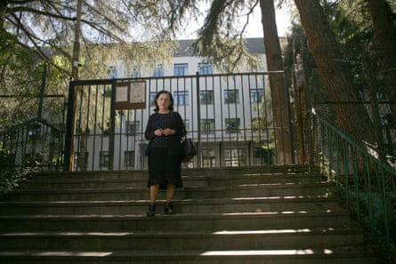 Manana Merabishvili, a teacher in the Georgian capital Tibilisi who taught a young Khvicha Kvaratskhelia, poses for a photo on a set of steps in front of a gate
