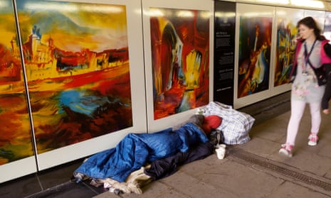 People walking past a homeless person sleeping on the street, Tower Hill, London