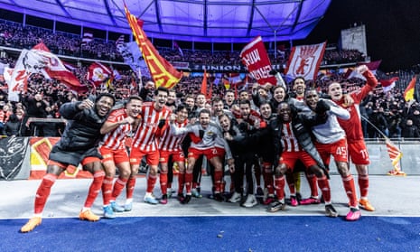 Players of Union Berlin celebrate after winning the derby with Hertha.