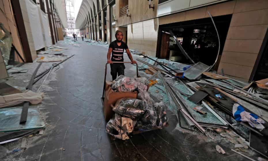 a man clears debris in beirut city centre