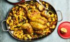 A metal dish with roast chicken, butter beans and shallots