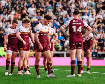 Huddersfield Giants’ players gather together in disappointment after conceding a try in their 52-0 Super League defeat at Leeds Rhinos.