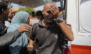 A man cries as injured Palestinians, including children, are transferred to al-Aqsa hospital after an Israeli attack on al-Magazi refugee camp in central Gaza.
