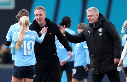 Manchester City manager Andrée Jeglertz (second left) shakes hands with his players
