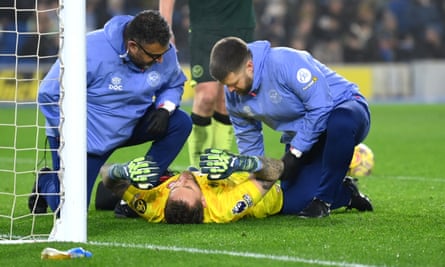 Mark Flekken receives medical attention during the Premier League match between Brighton and Brentford
