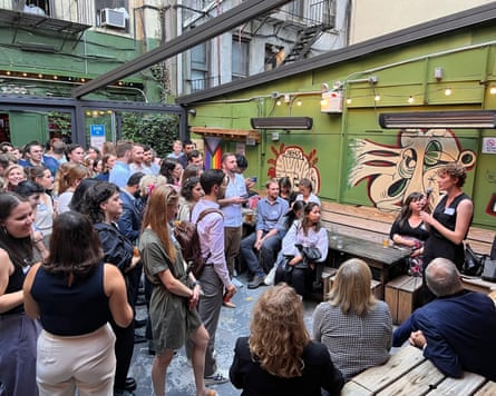 group of people inside building with beams above head