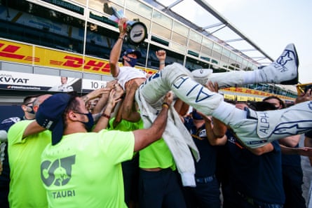 Pierre Gasly is hoisted in the air by his AlphaTauri colleagues.