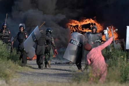 A supporter of Imran Khan throws a stone towards police officers during clashes in Islamabad on 10 May.