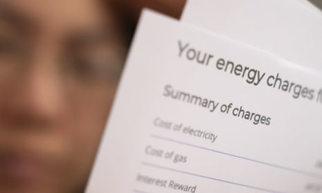 Part of an energy bill summary of charges printed on white paper, with blurred face in the background