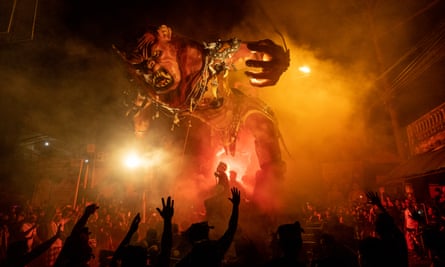 Balinese men carry the Ogoh-Ogoh during a parade on the eve of Nyepi