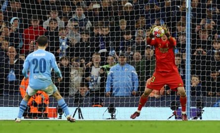 Real Madrid’s Andriy Lunin saves a penalty taken by Manchester City’s Bernardo Silva