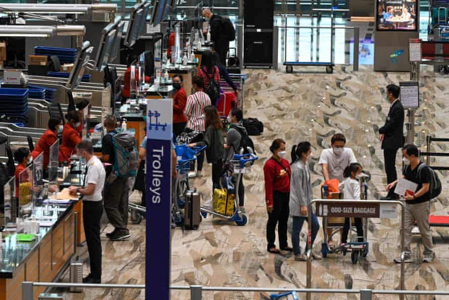 Travellers astatine  a check-in antagonistic  astatine  Changi airdrome  successful  Singapore