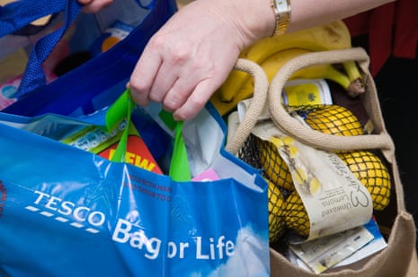 Woman carrying her shopping in reusable shopping ‘bags for life’