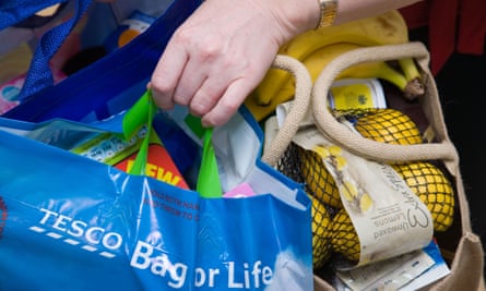 Woman carrying her shopping in reusable ‘bags for life’ shopping bags