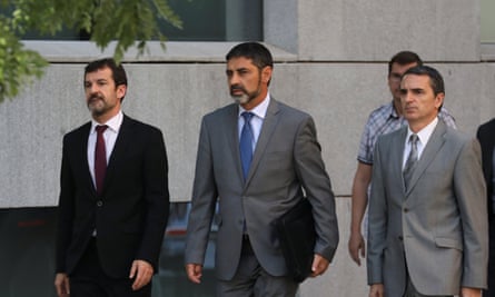 Josep Lluís Trapero, centre, the head of the Mossos d’Esquadra, the Catalan regional police force, returns to the High Court following a break in proceedings in Madrid.