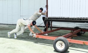 DIY: Ben Stokes and Matthew Fisher of England push the sightscreen .