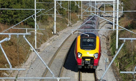 A train travels along a section of the West Coast Mainline