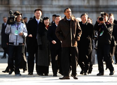 President Barack Obama tours the Forbidden City with press and others behind him