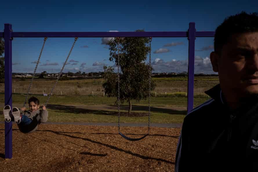 Jade Seenarain with his son Aryan. The parkland around the Elements estate remains barren and undeveloped, he says.