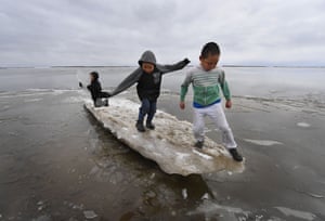 Children play on melting ice near the Yupik Inuit village of Napakiak on the Yukon Delta.