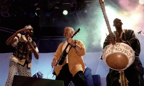 Simon Emmerson, centre, performing with Moussa Sissokho and N'Faly Kouyate of Afro Celt Sound System at the Glastonbury festival in 1999.