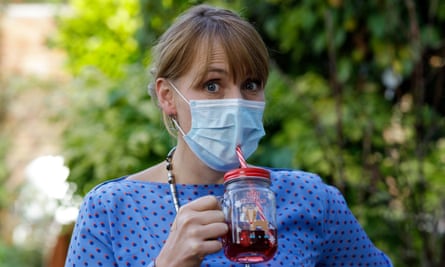 Model drinking with straw inserted through mask