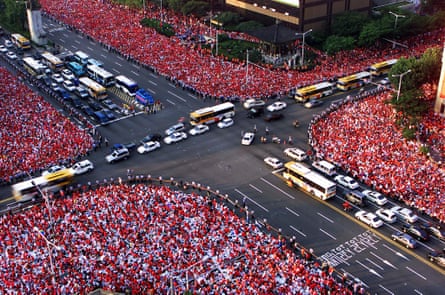 Tens of thousands of South Korean fans cheer their team in central Seoul before watching their win over Italy.