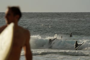 People surf at Bondi Beach
