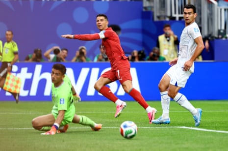 Cristiano Ronaldo passes the ball into the net for his second, and Portugal’s third, goal of the game.